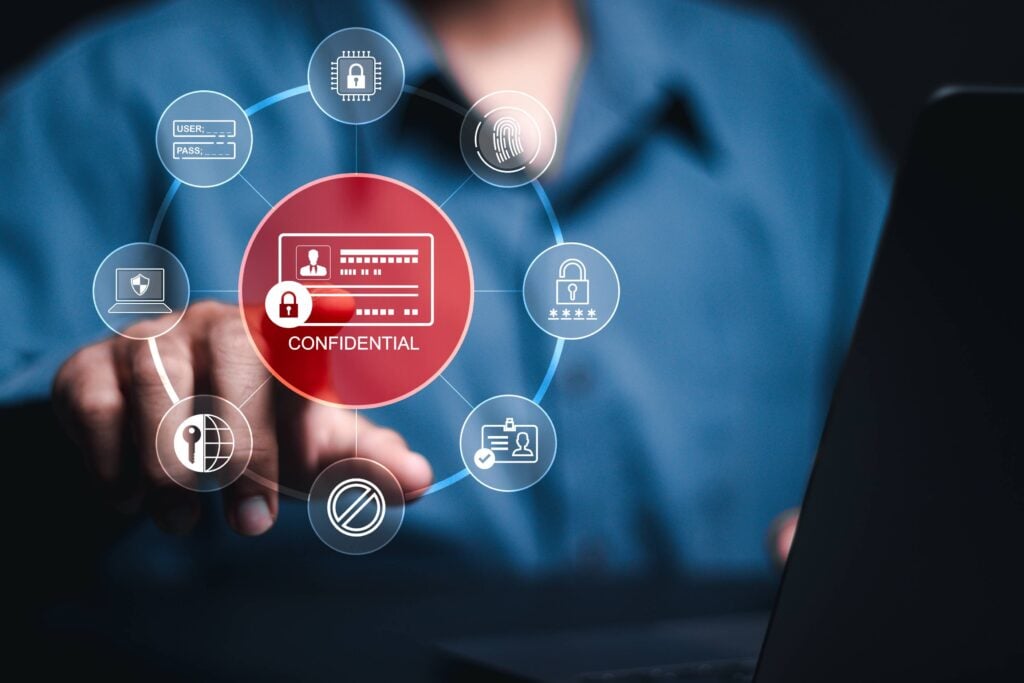 A person's hand touching a glowing "CONFIDENTIAL" digital interface surrounded by cybersecurity and data privacy icons.
